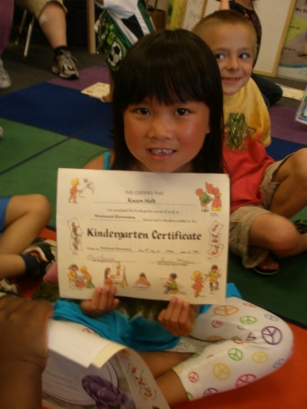 Kasen with her kindergarten certificate